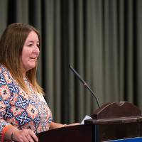Woman giving speech at podium